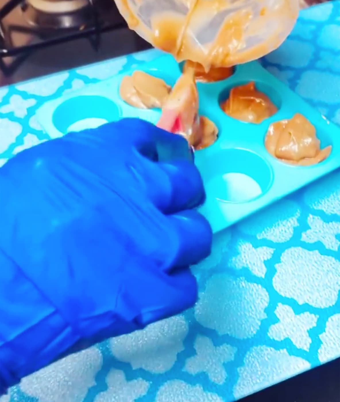 Pouring fresh cold-process soap batter into a silicone mould
